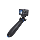 Black selfie stick with blue accents holding an action camera, closed grip view