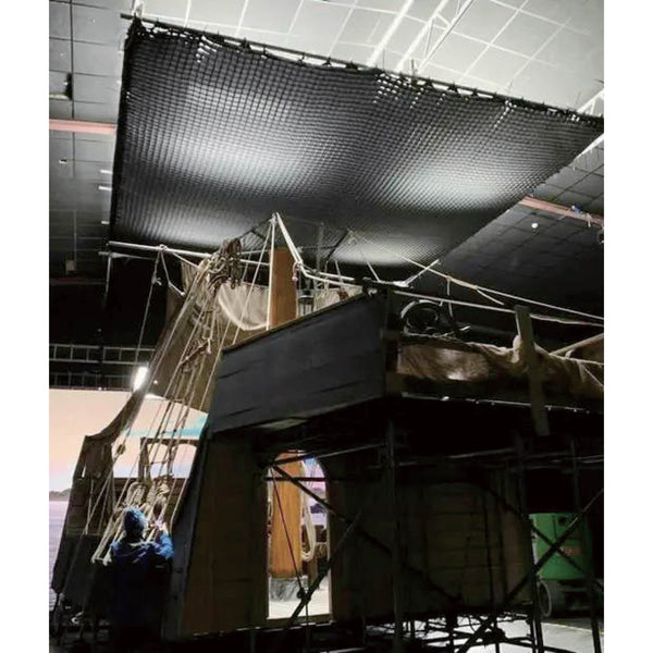 PiXAPRO 4x4cm Soft Grid for 240x240cm Butterfly Frame Scrim Diffuser being used in on a ceiling truss system