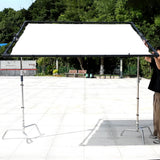PiXAPRO Heavy-Duty Butterfly Frame Sun Diffuser Panel mounted to two C-Stands in an outdoor location (C-Stands are NOT included)
