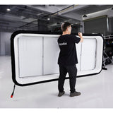 Gaffer carrying a Godox KNOWLED AM1600R-48K 4'x8' Inflatable RGB LED Light Mat