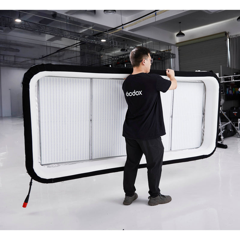 Gaffer carrying a Godox KNOWLED AM1600R-48K 4'x8' Inflatable RGB LED Light Mat