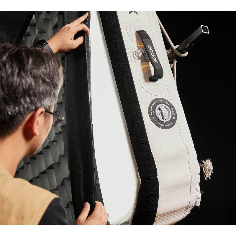 Gaffer attaching a grid to a Godox KNOWLED AM1600R-88K 8'x8' Inflatable RGB LED Light Mat