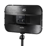The Back side of a Godox ES45 portable studio light on a stand, featuring a brushed black metal body with a digital control panel, set against a plain white background.