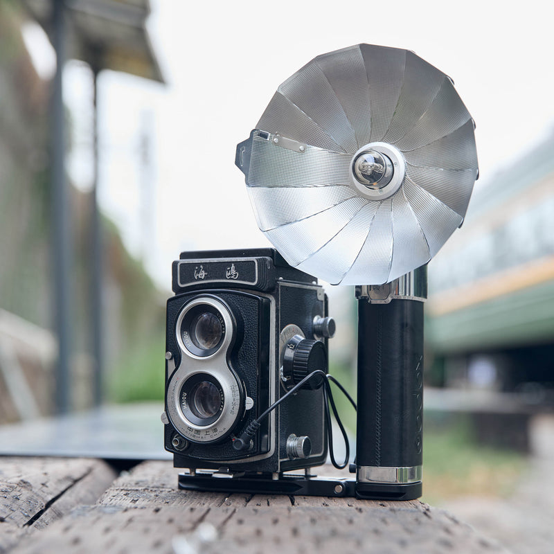 Godox FB01 Camera Mount Flash Bracket with a LUX Master flash and an old twin-lens reflex camera mounted to it