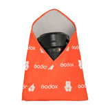 A  Godox GC01 Magic Wrap being used to wrap a camera lens