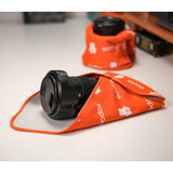 A  Godox GC01 Magic Wrap being used to wrap a camera lens