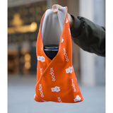 A phootgrapher demonstrating the Godox GC01 Magic Wrap's adhesion feature