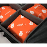 Multiple Godox GC01 Magic Wrape being used to wrap a  equipment in a camera bag