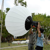 GODOX KNOLED GL7 7-Foot G-Mount Lantern Diffuser being mounted to a Knowled MG6K light fixture outdoors