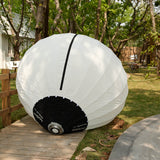 GODOX KNOLED GL7 7-Foot G-Mount Lantern Diffuser on the ground next to a fence to show size