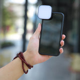 GODOX LEDM32 Clip-On Smartphone LED  Light Front View mounted to a smartphone held in a person's hand