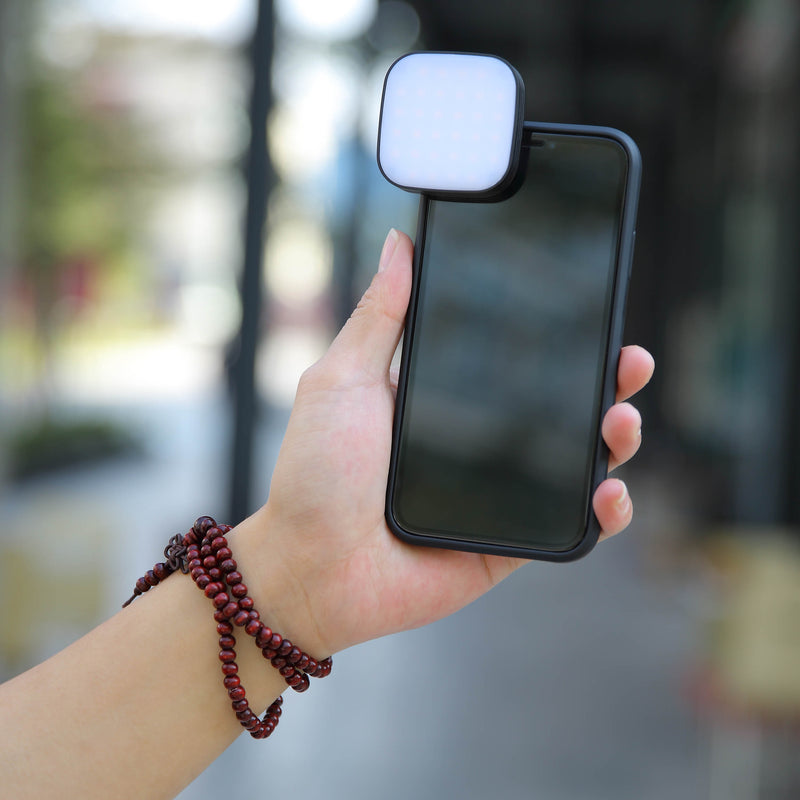 GODOX LEDM32 Clip-On Smartphone LED  Light Front View mounted to a smartphone held in a person's hand