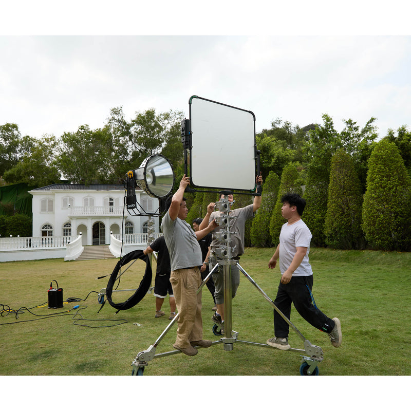 GODOX LF100MPY Motorised Yoke for KNOWLED LiteFlow100 Cine Reflector Panels being mounted to a wind up stand by a film crew