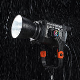 A GODOX KNOWLED M300R being used in the rain to illustrate its i54 weather resistance