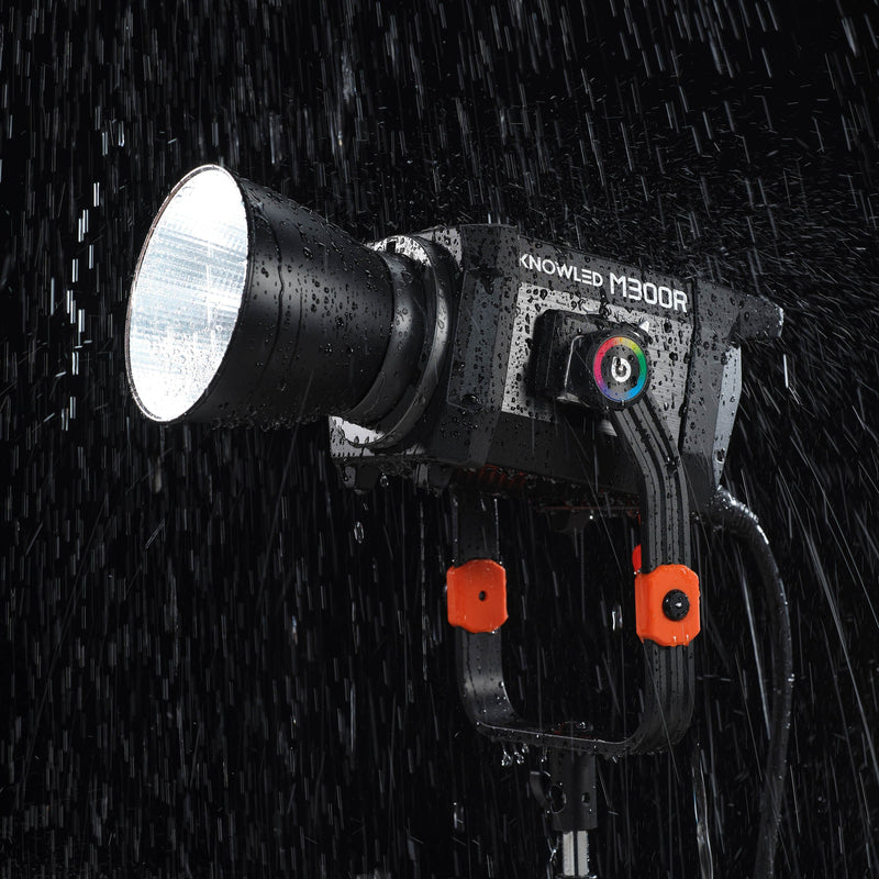 A GODOX KNOWLED M300R being used in the rain to illustrate its i54 weather resistance