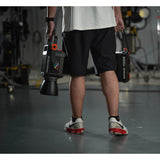 a Gaffer carrying an M300R in one hand and its controller box in the other to show portability