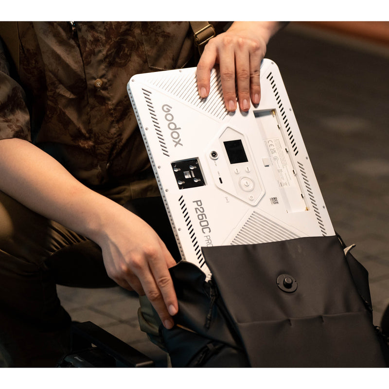 Godox P260C Pro Edge-Lit Bi-Colour LED Panel being placed inside a backpack