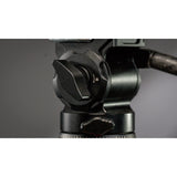 Close-up of a camera tripod head on a gray background
