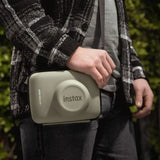 Protective case  for the Instax WIDE400 Instant camera on a white background being carried by a photographer
