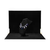 Two panels of the 60x60x60cm Black Velvet Tabletop Product-Photography Background Kit being used to photograph jewellery