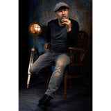 A man sitting on a wooden chair in a dimly lit room with a vintage lamp in front of a 2x3 Abstract Background Texture Studio Photography Background By Kate Backdrops