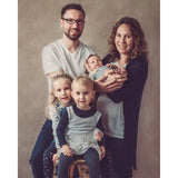 A Family of five with two adults, two children, and a baby against a 2x3 Abstract Brown Beige Little Green Colour Studio Microfibre Photography Backdrop by Kate Backdrops