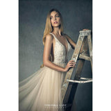 Woman in an elegant dress holding a wooden ladder against a 2x3 Cold Tones Of Grey And Little Green Light Abstract Textured Studio Photography Backdrop from Kate Backdrops with 'Veronika Gant Photography' credit.