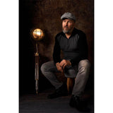 A man sitting on a stool with a lamp in front of a Kate Backdrops 2x3 Brown Concrete Textured Abstract Studio Photography Backdrop