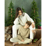 A Lady and a young boy sitting on a brown leather sofa in front of a Abstract Olive Green Textured Studio Photography Backdrop