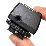 A person holding a PiXAPRO Universal PC Sync Adapter, Showing its 3.5mm Sync jack
