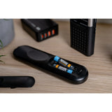 Two Newell USB-C Rechargeable  batteries, being used in a remote control on a table with other electronic devices 