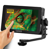 OSEE touchscreen monitor displaying a chameleon's eye, with a hand interacting with it.