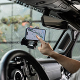 A person using a smartphone with a GPS app mounted on a car dashboard using the PGYTECH CapLock Action Camera Suction Cup Mount 