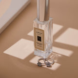 An example product photo of a perfume bottle and two rings taken using the PiXAPRO Double-Side A3 Soft Diffuser Gobo For Product Photography