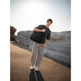 SAKK GEAR Organisational Tote Bag Model on Location posing with bag over shoulder