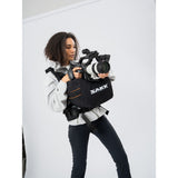 SAKK GEAR Sakk Attach Photographer standing holding camera from on-top of case