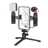 A mobile phone video call setup on a SmallRig All-in-One Video Kit. Featuring a silver-framed phone holder in the centre, a white square light on the left, and a black microphone with a red clip on the right. The brand 'Loadring' is visible on the tripod base and the light body.