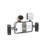 A SmallRig All-in-One mobile phone camera rig with a black metal cage, side grips, a built-in microphone, and a white external light panel, shown on a solid white background.