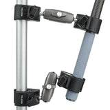 Crab clamps fastened around a metal pole and a selfie stick handle