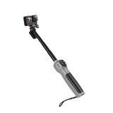 Extended TELESIN remote selfie stick with GoPro mounted, black grip and wrist strap.