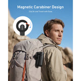 Folded Telesin magnetic selfie stick clipped to a hiker’s backpack using the built-in carabiner
