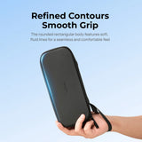 Black Telesin camera case held in one hand, showing rounded corners and wrist strap