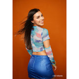 A model in front of the Westcott Tiger Orange 5'x12' backdrop fabric for the X-Drop System