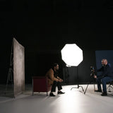 Westcott X-Drop Telescopic Background Support System Being used in a studio to photograph a subject