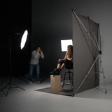 Westcott X-Drop Telescopic Background Support System Being used in a studio to photograph a subject