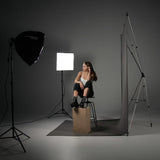 Westcott X-Drop Telescopic Background Support System Being used in a studio to photograph a subject