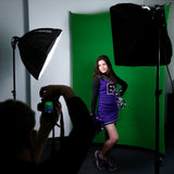 A model in front of a Westcott Chromakey Green 5'x7' backdrop fabric for the X-Drop System