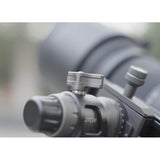 Close-up of an MH38A Windmill Panoramic Head with a large telephoto lens mounted to it on an out-of-focused background
