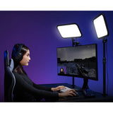 Person using a computer with two  ES45 LED lights on a purple background